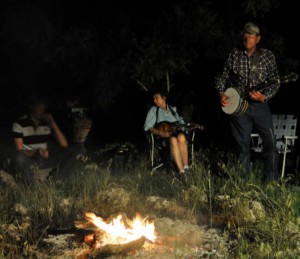 John and Kris Erickson perform by campfire light