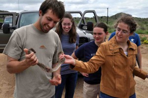 students holding snake